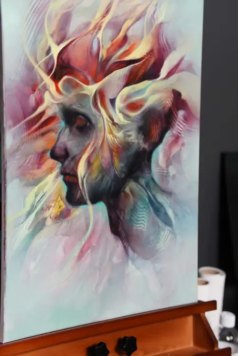 colour abstract face painting on canvas, viewed at an angle on the easel