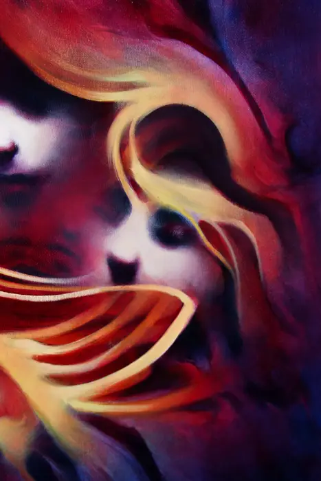 close up detail of a red and purple abstract face painting with cream brush lines