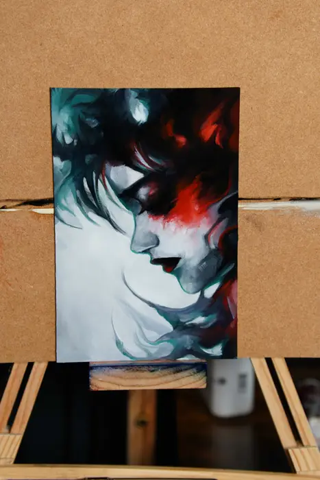 red and teal oil study of a woman's face in profile on a small canvas board