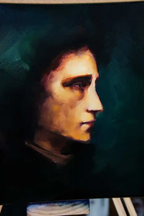 warm lit profile portrait oil study on a dark green background
