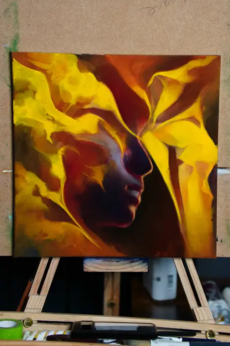 yellow and red oil painting of a face emerging from abstract petals on canvas