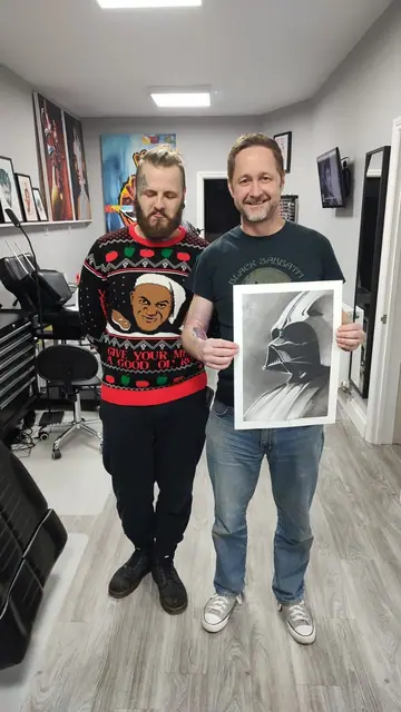 black and grey darth vader portrait on inner forearm