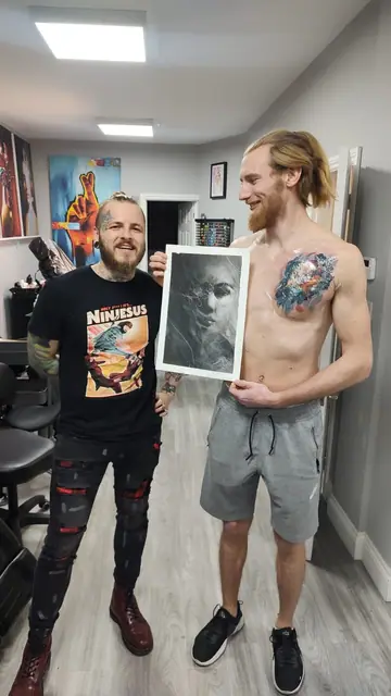 colour realism abstract face tattoo on chest, with artist and reference photo