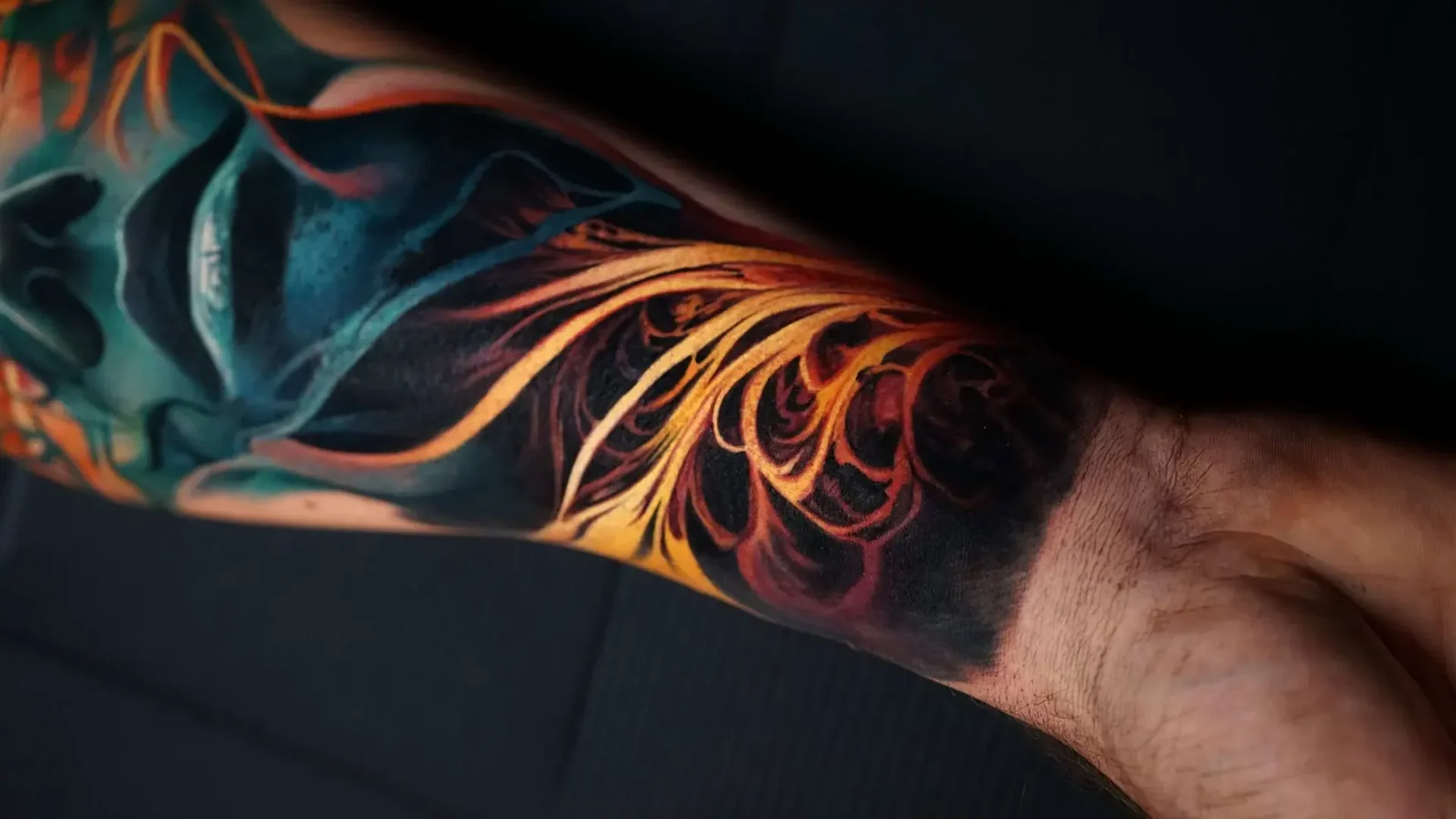 colour realism abstract fluid shapes tattoo on forearm