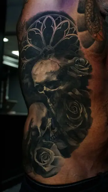 black and grey skull, roses, gothic window tattoo on ribs