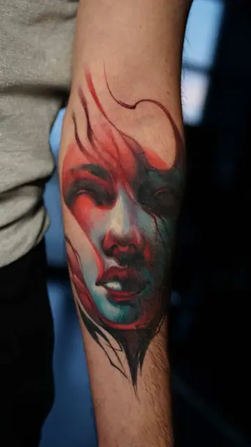 colour realism abstract female face tattoo on forearm