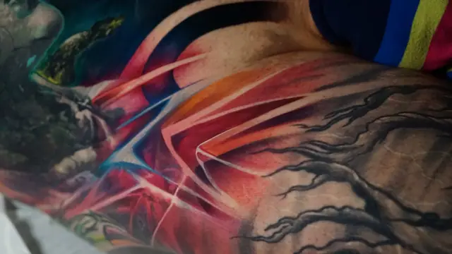 colour realism abstract figure and tree tattoo on arm