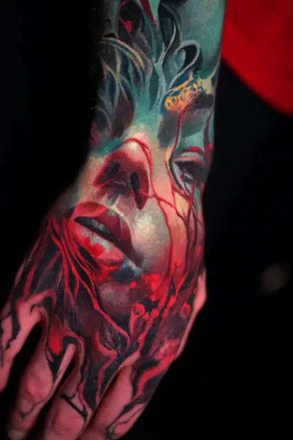 colour realism crying face and veins tattoo on hand