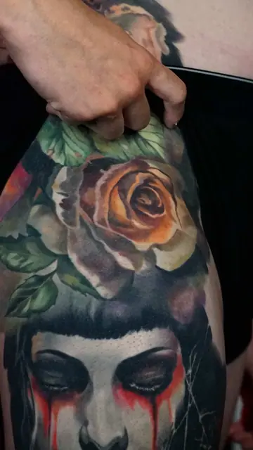 colour realism crying woman and rose tattoo on thigh
