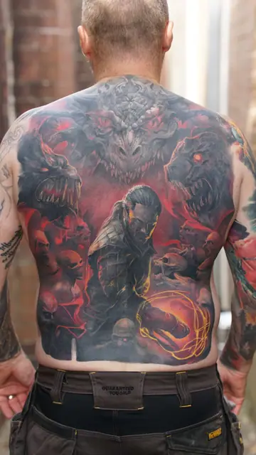 colour realism demon battle scene tattoo on full back
