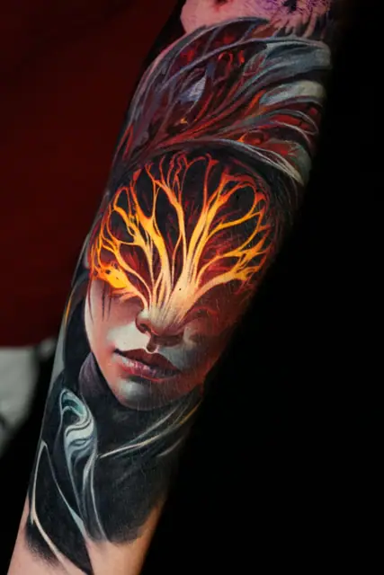 colour realism glowing face tattoo on arm sleeve