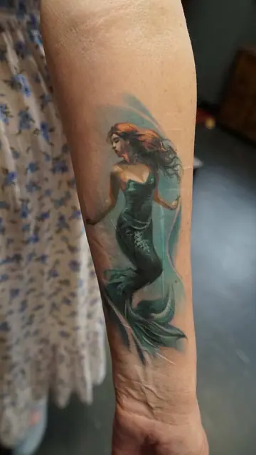 colour realism mermaid tattoo on forearm