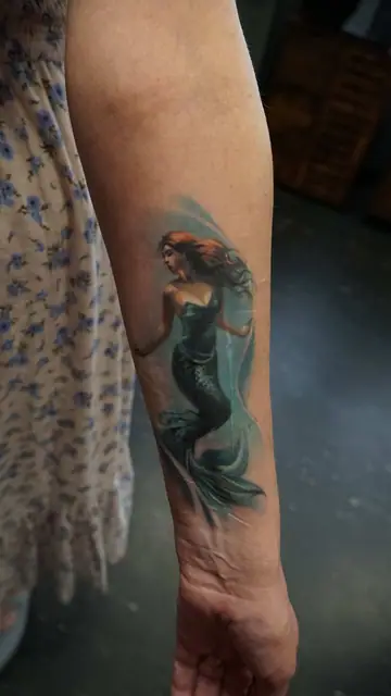 colour realism mermaid tattoo on forearm
