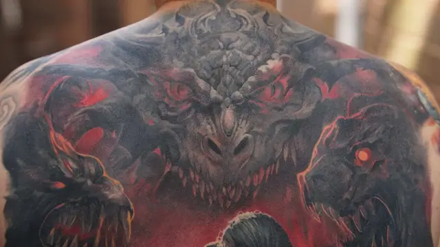 colour realism monster/dragon heads tattoo on upper back