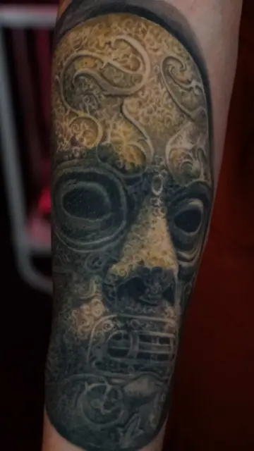 colour realism ornate mask tattoo on forearm