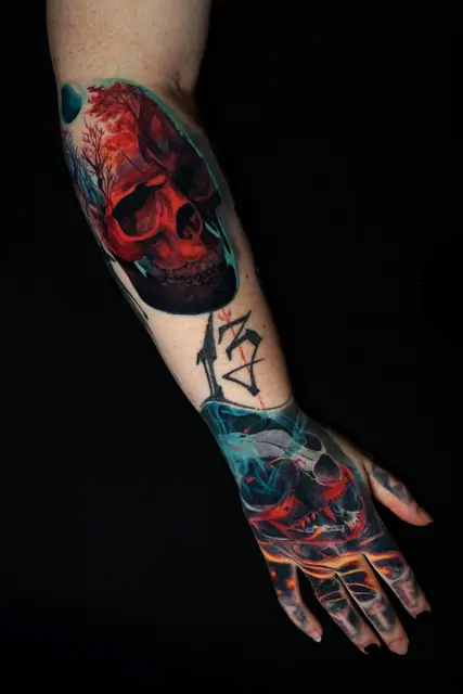 colour realism skull and abstract designs tattoo on arm and hand