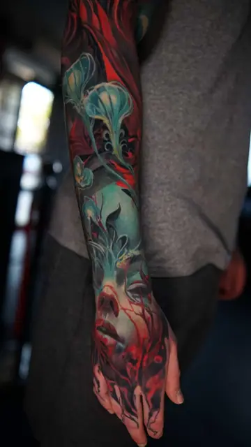 colour realism woman's face and glowing plants full sleeve tattoo