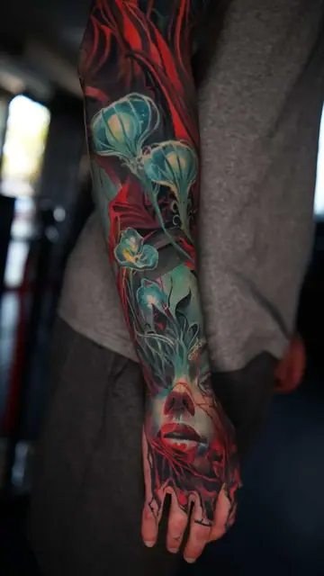 colour realism woman's face and jellyfish full sleeve tattoo