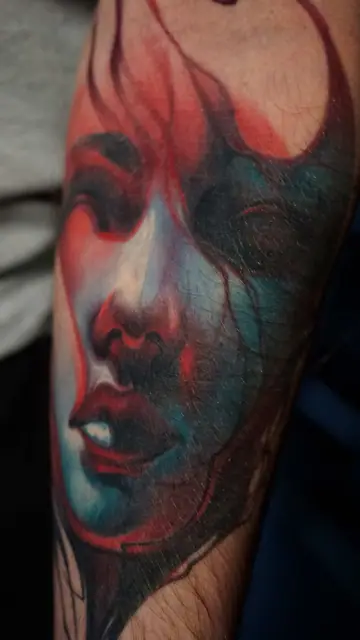 colour realism woman's face tattoo on arm