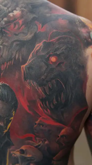 demonic beast colour realism tattoo on upper back with red glow