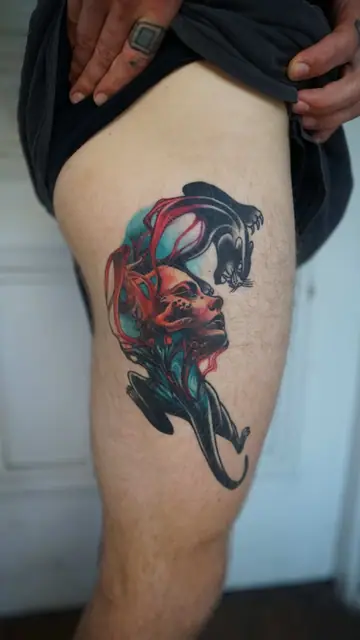neo-traditional panther and woman tattoo on upper thigh