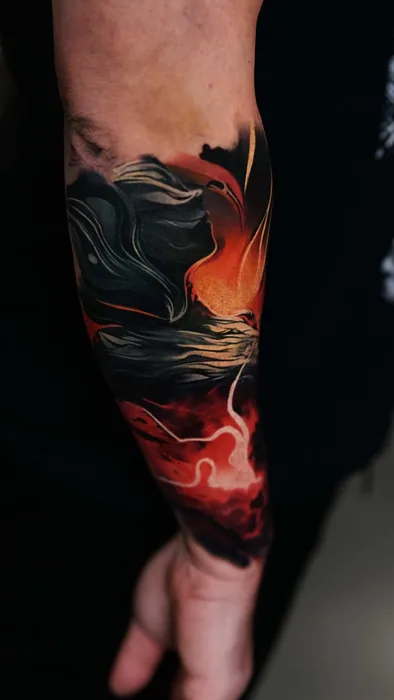 abstract colour realism black smoke and orange flame tattoo on forearm