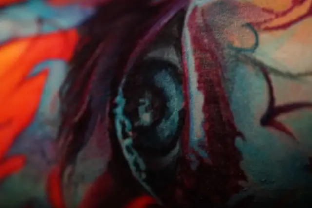 abstract color tattoo detail, possibly eye, on skin