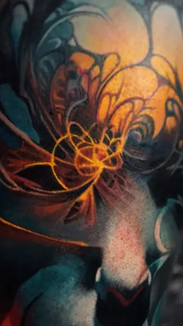 abstract color tattoo with orange glow on shoulder