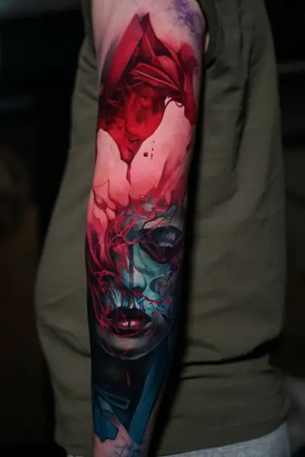 abstract female face and geometric full colour tattoo on arm