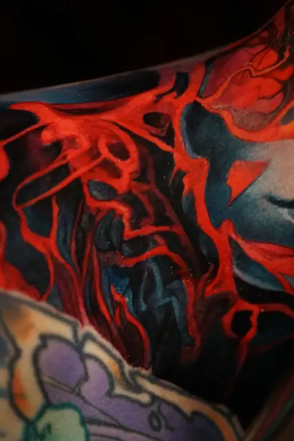 abstract red and blue colour realism tattoo on skin