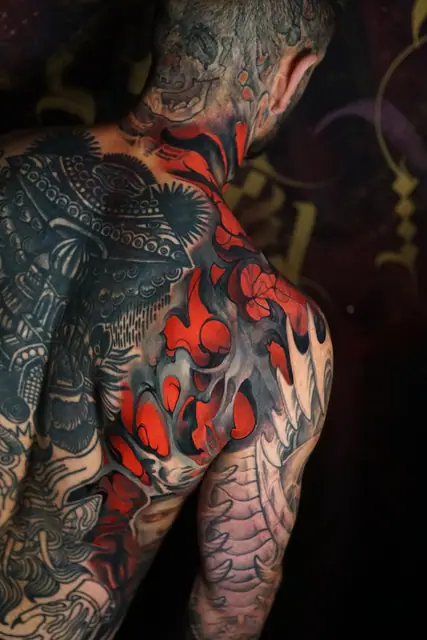 biomechanical colour tattoo on back, shoulder and neck