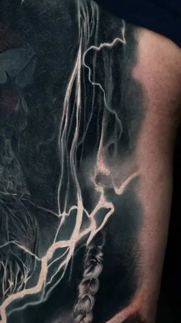 black and grey fantasy warrior with lightning on back shoulder