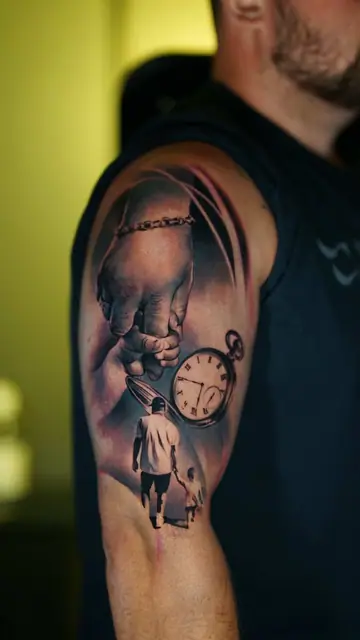 black and grey realism journey tattoo on upper arm