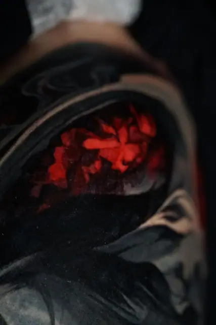 black and red abstract tattoo on arm