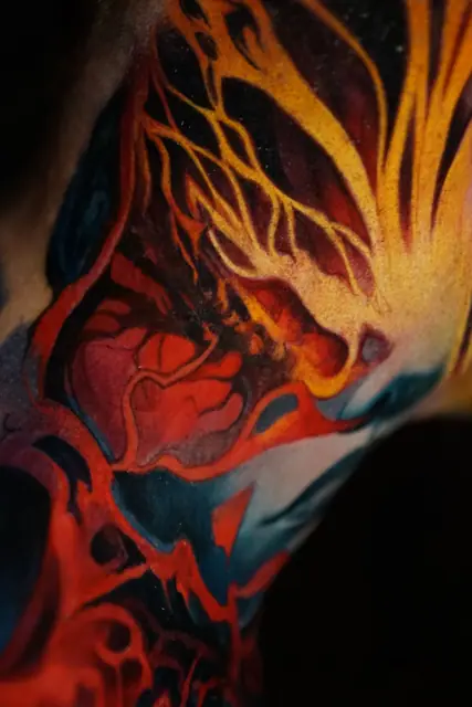 colour abstract fiery patterns tattoo on arm/shoulder/neck area