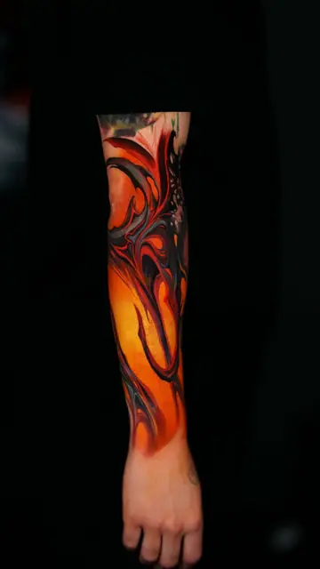 colour fluid abstract tattoo on full forearm and hand