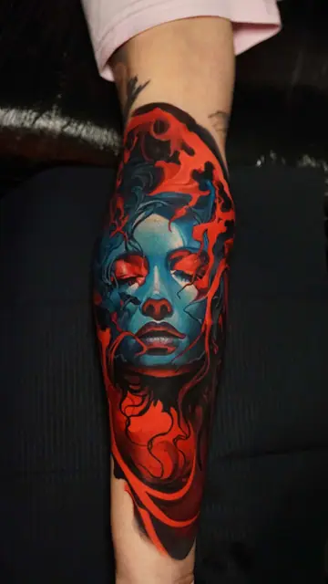 colour portrait woman's face with red and blue on forearm