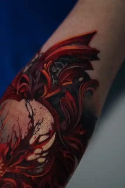 colour realism abstract demon/fiery tattoo on forearm
