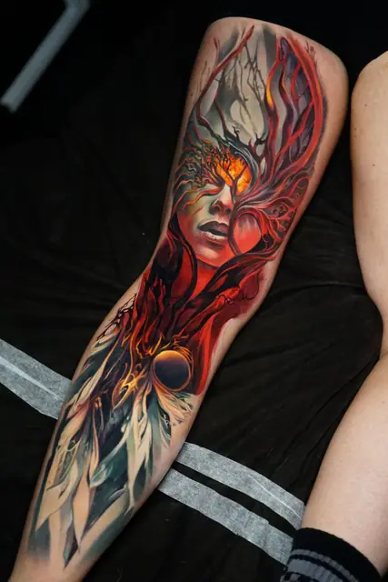 colour realism abstract face with roots and orb full leg tattoo
