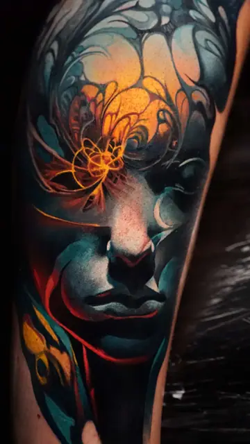colour realism abstract face tattoo on leg