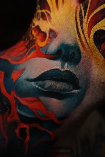 colour realism abstract face tattoo on neck and shoulder