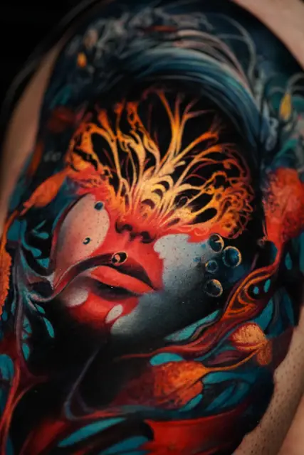 colour realism abstract face tattoo on upper arm