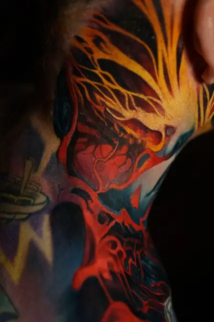 colour realism abstract flame heart tattoo on neck