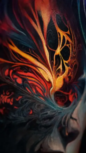 colour realism abstract flowing fire tattoo on torso