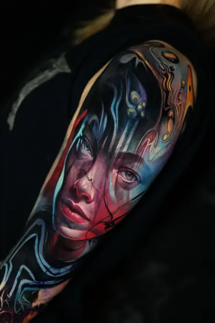 colour realism abstract portrait tattoo on upper arm