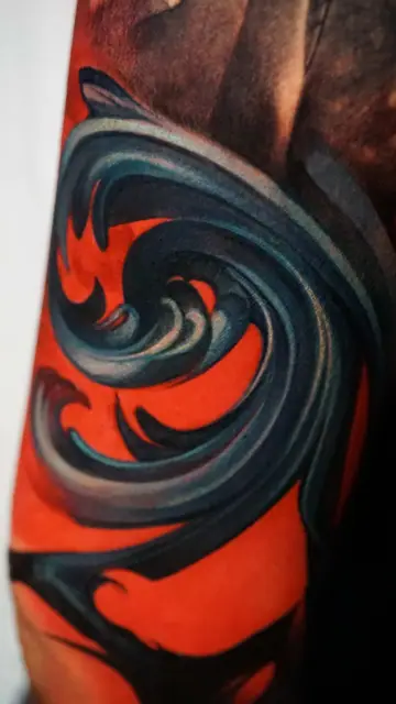 colour realism abstract wave swirl tattoo on arm