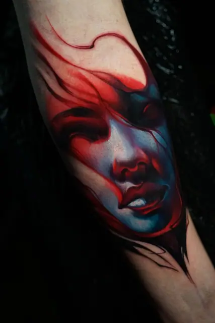 colour realism abstract woman's face tattoo on forearm