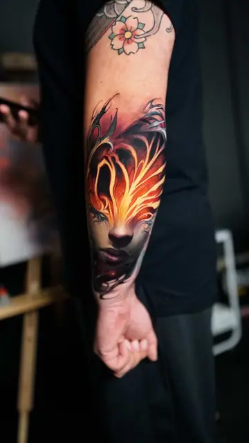 colour realism burning face tattoo on forearm