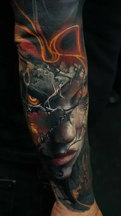 colour realism cracked stone woman's face with fire tattoo on forearm