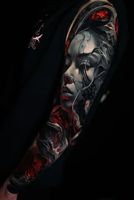 colour realism cover up of a dark woman's face tattoo on outer arm
